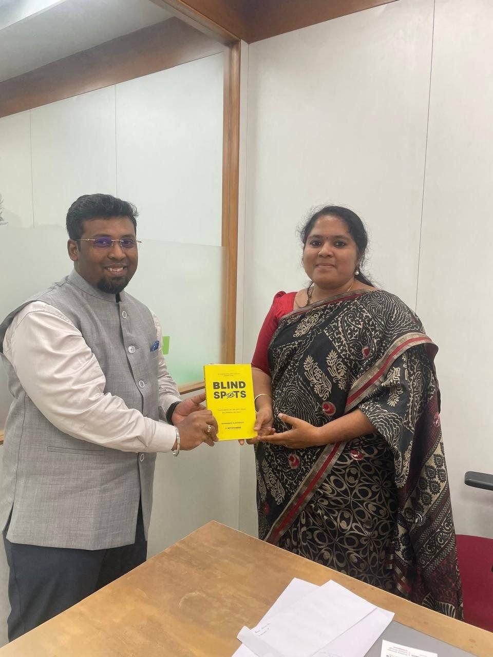 Sivakumar Alagumalai handing BLINDSPOTS to Ms. Surya, Principal, Aditya Vidyashram
