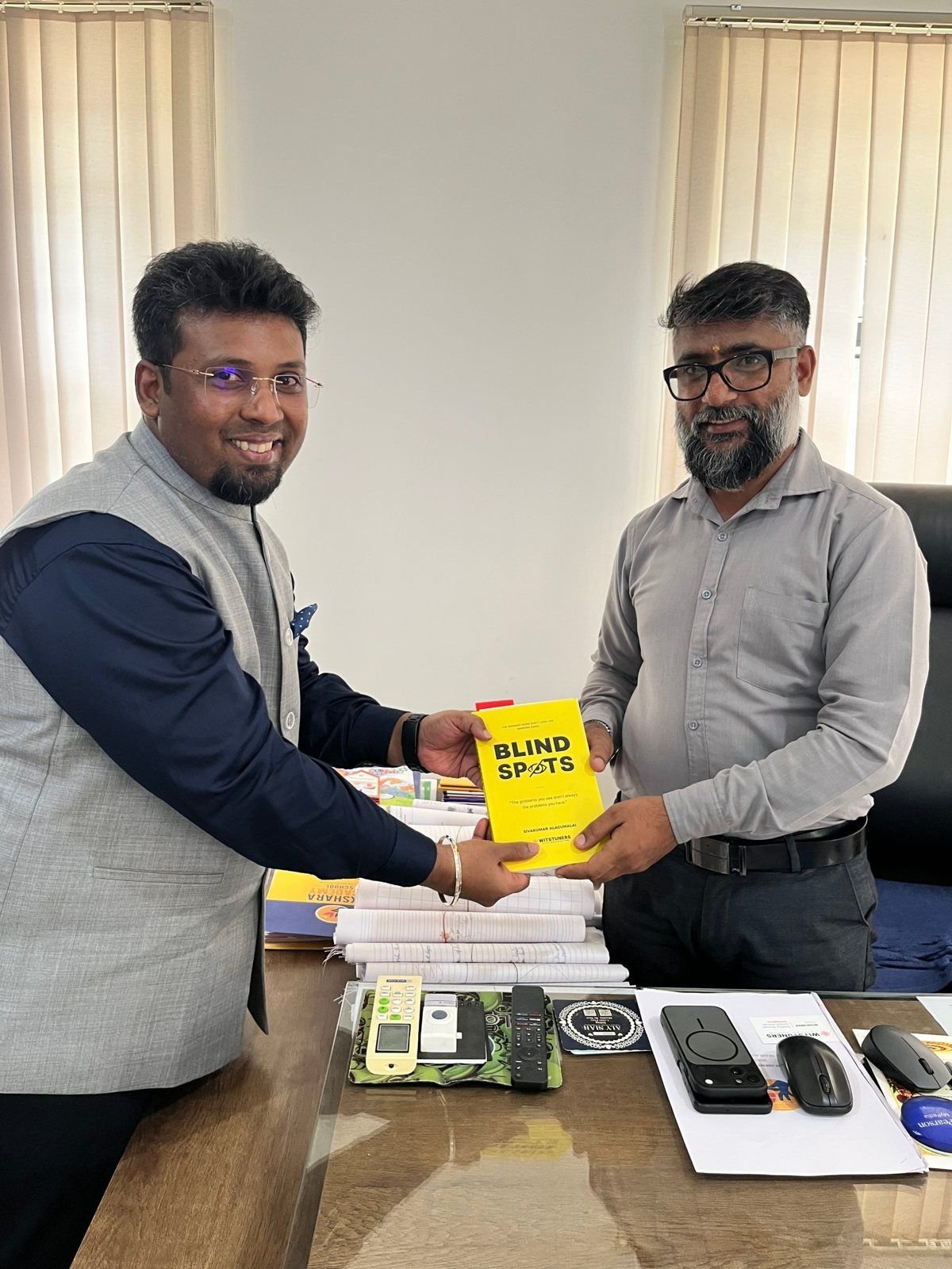 Sivakumar Alagumalai handing BLINDSPOTS to Mr. Shankar, Principal, Akshara Academy